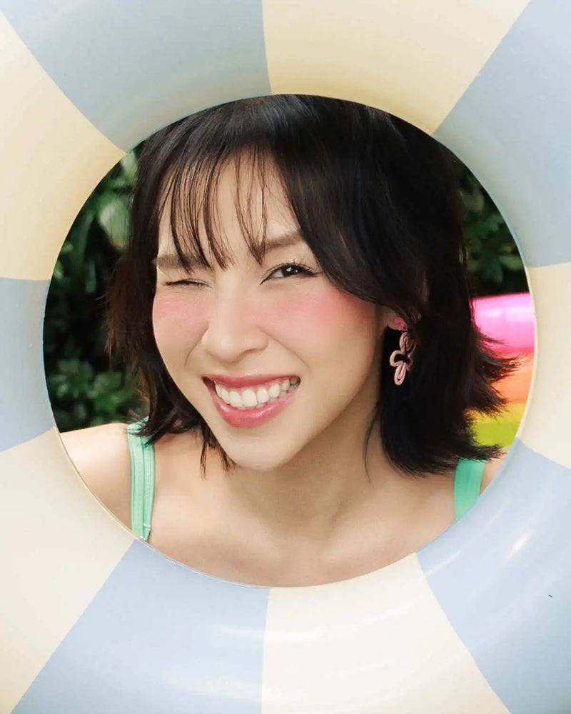 Woman with a smile in front of a colorful geometric background